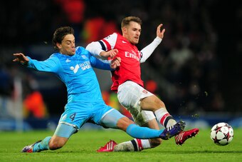LONDON, ENGLAND - NOVEMBER 26:  Lucas Mendes of Marseille and Aaron Ramsey of Arsenal battle for the ball during the UEFA Champions League Group F match between Arsenal and Olympique de Marseille at Emirates Stadium on November 26, 2013 in London, England