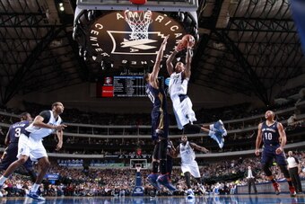DALLAS, TX - JANUARY 11: Monta Ellis #11 of the Dallas Mavericks goes in for the lay up against Anthony Davis #23 of the New Orleans Pelicans on January 11, 2014 at the American Airlines Center in Dallas, Texas. NOTE TO USER: User expressly acknowledges a