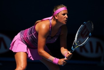 MELBOURNE, AUSTRALIA - JANUARY 14:  Victoria Azarenka of Belarus prepares to return serve in her first round match against Johanna Larsson of Sweden during day two of the 2014 Australian Open at Melbourne Park on January 14, 2014 in Melbourne, Australia.