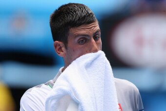 MELBOURNE, AUSTRALIA - JANUARY 15:  Novak Djokovic of Serbia wipes his face in his second round match against Leonardo Mayer of Argentina during day three of the 2014 Australian Open at Melbourne Park on January 15, 2014 in Melbourne, Australia.  (Photo b