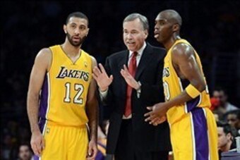 Jan 14, 2014; Los Angeles, CA, USA; Los Angeles Lakers head coach Mike D'Antoni talks to point guard Kendall Marshall (12) and shooting guard Jodie Meeks (20) in the second half of the game against the Cleveland Cavaliers at Staples Center. Cleveland Cava