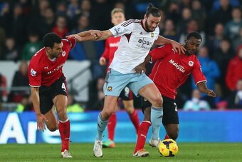 CARDIFF, WALES - JANUARY 11:  Andy Carroll (C) of West Ham United battles with Kevin Theophile-Catherine and Steven Caulker (L) of Cardiff City during the Barclays Premier League match between Cardiff City and West Ham United at the Cardiff City Stadium o