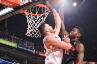 PHOENIX, AZ - DECEMBER 6: Amir Johnson #15 of the Toronto Raptors tries to dunk against Miles Plumlee #22 of the Phoenix Suns on December 6, 2013 at U.S. Airways Center in Phoenix, Arizona. NOTE TO USER: User expressly acknowledges and agrees that, by dow