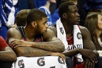 Dec 28, 2013; Lexington, KY, USA; Louisville Cardinals forward Chane Behanan (21) and forward/center Mangok Mathiang (12) look on from the bench during the second half against the Kentucky Wildcats at Rupp Arena. Kentucky defeated Louisville 73-66.  Manda