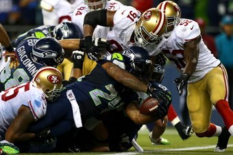 SEATTLE - SEPTEMBER 15:  Marshawn Lynch #24 of the Seattle Seahawks stretches the ball across the goal line for a touchdown against the San Francisco 49ers on September 15, 2013 at Century Link Field in Seattle, Washington.  (Photo by Jonathan Ferrey/Gett