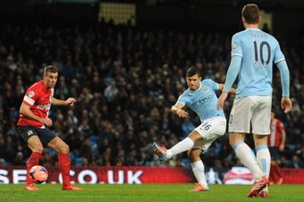 MANCHESTER, ENGLAND - JANUARY 15:  Sergio Aguero of Manchester City scores his team's fourth goal during the Budweiser FA Cup Third Round Replay match between Manchester City and Blackburn Rovers at the Etihad Stadium on January 15, 2014 in Manchester, En