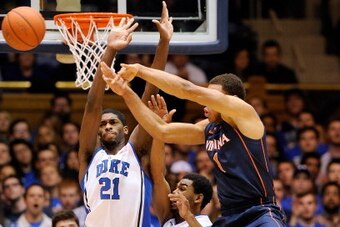 DURHAM, NC - JANUARY 13:  Amile Jefferson #21 and Matt Jones #13 of the Duke Blue Devils defend on a drive by Justin Anderson #1 of the Virginia Cavaliers during a game at Cameron Indoor Stadium on January 13, 2014 in Durham, North Carolina.  (Photo by Gr