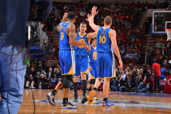 PHILADELPHIA, PA - NOVEMBER 4:  Andrew Bogut #12 high fives Andre Iguodala #9 and David Lee #10 of the Golden State Warriorsas they celebrate a play against the Philadelphia 76ers at the Wells Fargo Center on November 4, 2013 in Philadelphia, Pennsylvania