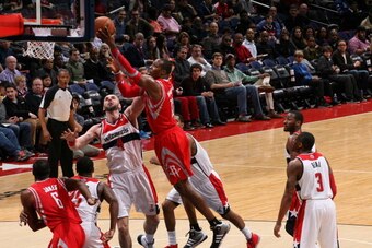 WASHINGTON, DC - JANUARY 11: Dwight Howard #12 of the Houston Rockets shoots against Marcin Gortat #4 of the Washington Wizards during the game at the Verizon Center on January 11, 2014 in Washington, DC. NOTE TO USER: User expressly acknowledges and agre