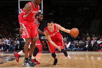 WASHINGTON, DC - JANUARY 11: Jeremy Lin #7 of the Houston Rockets drives against John Wall #2 of the Washington Wizards during the game at the Verizon Center on January 11, 2014 in Washington, DC. NOTE TO USER: User expressly acknowledges and agrees that,
