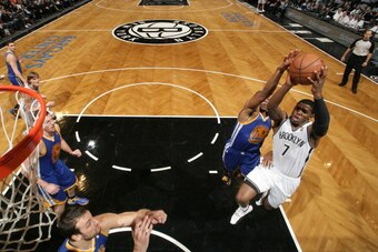 NEW YORK, NY - JANUARY 08: Joe Johnson #7 of the Brooklyn Nets shoots against Andre Iguodala #9 of the Golden State Warriors during a game at the Barclays Center on January 8, 2014 in the Brooklyn borough of New York City.  NOTE TO USER: User expressly ac