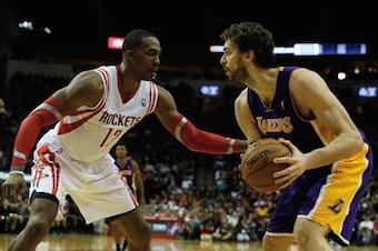 HOUSTON, TX - JANUARY 08: Pau Gasol #16 of the Los Angeles Lakers works the ball against Dwight Howard #12 of the Houston Rockets during the game at the Toyota Center on January 8, 2014 in Houston, Texas. NOTE TO USER: User expressly acknowledges and agr HOUSTON, TX - JANUARY 08: Pau Gasol #16 of the Los Angeles Lakers works the ball against Dwight Howard #12 of the Houston Rockets during the game at the Toyota Center on January 8, 2014 in Houston, Texas. NOTE TO USER: User expressly acknowledges and agr