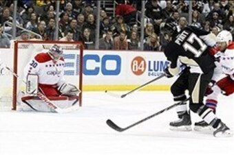 Jan 15, 2014; Pittsburgh, PA, USA; Pittsburgh Penguins left wing Taylor Pyatt (17) shoots and scores past Washington Capitals goalie Michal Neuvirth (30) during the second period at the CONSOL Energy Center. Mandatory Credit: Charles LeClaire-USA TODAY Sp