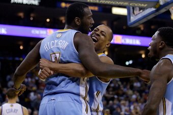OAKLAND, CA - JANUARY 15:  Randy Foye #4 (center) and Nate Robinson #10 congratulate J.J. Hickson #7 of the Denver Nuggets after Hickson stole the ball from Stephen Curry #30 of the Golden State Warriors and then made a lay-up in the final minute of their