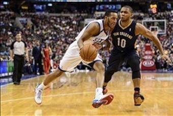 Nov 29, 2013; Philadelphia, PA, USA; Philadelphia 76ers guard Evan Turner (12) is defended by New Orleans Pelicans guard Eric Gordon (10) during the third quarter at the Wells Fargo Center. The Pelicans defeated the Sixers 121-105. Mandatory Credit: Howar