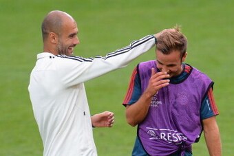 PRAGUE, CZECH REPUBLIC - AUGUST 29:  Pep Guardiola the FC Bayern Munchen coach shares a joke with player Mario Gotze during a training session prior to the UEFA Super Cup match between FC Bayern Munchen and Chelsea at Stadion Eden on August 29, 2013 in Pr