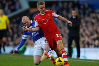 LIVERPOOL, ENGLAND - DECEMBER 29:  Luke Shaw of Southampton is tackled by Steven Naismith of Everton during the Barclays Premier League match between Everton and Southampton at Goodison Park on December 29, 2013 in Liverpool, England.  (Photo by Paul Thom