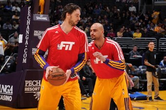 LOS ANGELES, CA - JANUARY 3: Pau Gasol #16 and Robert Sacre #50 of the Los Angeles Lakers warm up before a game against the Utah Jazz at STAPLES Center on January 3, 2013 in Los Angeles, California. NOTE TO USER: User expressly acknowledges and agrees tha