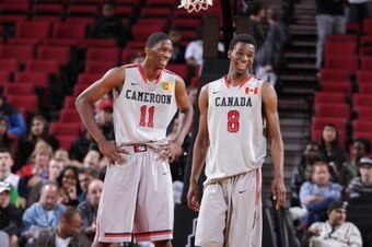 PORTLAND, OR - APRIL 20:  Joel Embiid #11 and Andrew Wiggins #8 of the World Select Team smile during the game against the USA Junior Select Team at the 2013 Nike Hoop Summit game on April 20, 2013 at the Rose Garden Arena in Portland, Oregon. NOTE TO USE