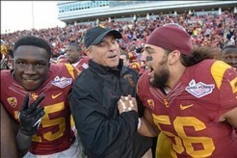 Dec 21, 2013; Las Vegas, NV, USA; Southern California Trojans interim coach Clay Helton (center) celebrates with linebacker Anthony Sarao (56) after the game against the Fresno State Bulldogs in the Las Vegas Bowl at Sam Boyd Stadium. USC defeated Fresno 