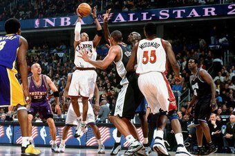 WASHINGTON D.C. - FEBRUARY 11:  Allen Iverson #3 of the Eastern Conference All-Stars attempts a shot against Tim Duncan #21 of the Western Conference All-Stars during the 2001 NBA All-Star Game held on February 11, 2001 at the MIC Center in Washington, D.