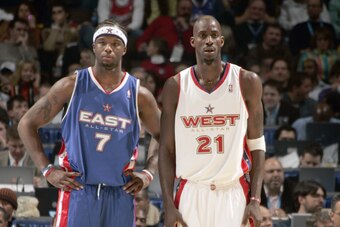 DENVER - FEBRUARY 20:  Jermaine O'Neal #7 of the Eastern Conference All-Stars and Kevin Garnett #21 of the Western Conference All-Stars look on during the 54th All-Star Game, part of 2005 NBA All-Star Weekend at Pepsi Center on February 20, 2005 in Denver