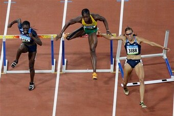 Jones clipping the hurdle in Beijing.