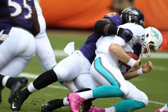 MIAMI GARDENS, FL - OCTOBER 06:  Quarterback Ryan Tannehill #17 of the Miami Dolphins is sacked by Linebacker Daryl Smith #51 of the Baltimore Ravens at Sun Life Stadium on October 6, 2013 in Miami Gardens, Florida.  (Photo by Marc Serota/Getty Images)