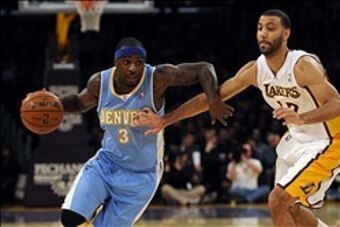 Jan 5, 2014; Los Angeles, CA, USA; Denver Nuggets guard Ty Lawson (3) drives the ball defended by Los Angeles Lakers guard Kendall Marshall (12) during the first period at Staples Center. Mandatory Credit: Kelvin Kuo-USA TODAY Sports