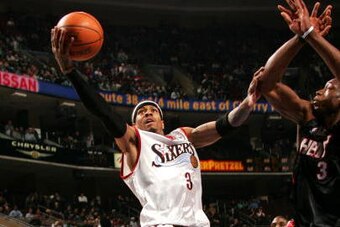 PHILADELPHIA - JANUARY 24:  Allen Iverson #3 of the Philadelphia 76ers lays one up against Dwyane Wade #3 of the Miami Heat on January 24, 2005 at the Wachovia Center in Philadelphia, Pennsylvania.  NOTE TO USER: User expressly acknowledges and agrees tha