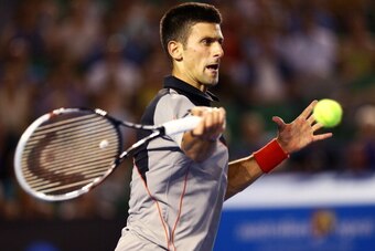 MELBOURNE, AUSTRALIA - JANUARY 17:  Novak Djokovic of Serbia plays a forehand in his third round match against Denis Istomin of Uzbekistan during day five of the 2014 Australian Open at Melbourne Park on January 17, 2014 in Melbourne, Australia.  (Photo b