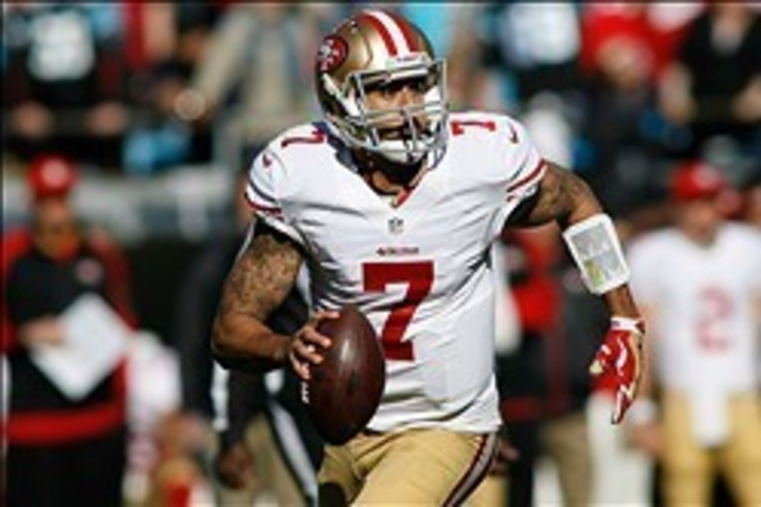 Jan 12, 2014; Charlotte, NC, USA; San Francisco 49ers quarterback Colin Kaepernick (7) rolls out of the pocket during the first quarter against the Carolina Panthers during the 2013 NFC divisional playoff football game at Bank of America Stadium. Mandator