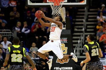 KANSAS CITY, MO - MARCH 14:  Marcus Smart #33 of the Oklahoma State Cowboys performs a reverse dunk during the quarterfinal game of the 2013 Men's Big 12 Championships against the Baylor Bears at Sprint Center on March 14, 2013 in Kansas City, Missouri.  
