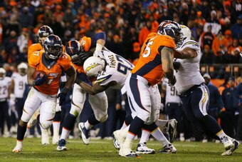 DENVER, CO - JANUARY 12:  Knowshon Moreno #27 of the Denver Broncos carries the ball against the San Diego Chargers during the AFC Divisional Playoff Game at Sports Authority Field at Mile High on January 12, 2014 in Denver, Colorado.  (Photo by Justin Ed