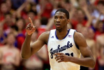 LAWRENCE, KS - JANUARY 18:  Joel Embiid #21 of the Kansas Jayhawks reacts after scoring during the game against the Oklahoma State Cowboys at Allen Fieldhouse on January 18, 2014 in Lawrence, Kansas.  (Photo by Jamie Squire/Getty Images)