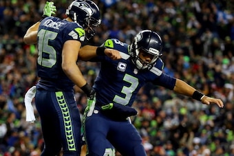 SEATTLE, WA - JANUARY 19:  Wide receiver Jermaine Kearse #15 of the Seattle Seahawks celebrates with quarterback Russell Wilson #3 after Kearse catches a 35-yard touchdown in the fourth quarter touchdown against the San Francisco 49ers during the 2014 NFC