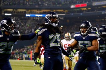 SEATTLE, WA - JANUARY 19:  Cornerback Richard Sherman #25 of the Seattle Seahawks celebrates after he tips the ball leading to an intereption by outside linebacker Malcolm Smith #53 to clinch the victory for the Seahawks against the San Francisco 49ers du