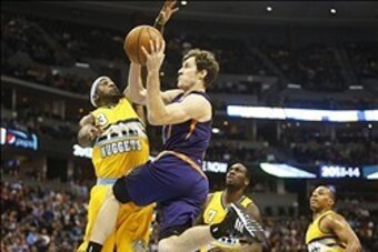 Dec 20, 2013; Denver, CO, USA; Phoenix Suns guard Goran Dragic (1)  shoots the ball against Denver Nuggets guard Ty Lawson (3) during the second half at Pepsi Center.  The Suns won 103-99.   Mandatory Credit: Chris Humphreys-USA TODAY Sports