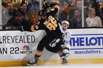 BOSTON, MA - JANUARY 20: Kevan Miller #86 of the Boston Bruins checks against Dustin Brown #23 of the Los Angeles Kings at the TD Garden on January 20, 2014 in Boston, Massachusetts.  (Photo by Brian Babineau/NHLI via Getty Images)