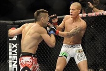 Jan 26, 2013; Chicago, IL, USA; Ricardo Lamas (red and black shorts) fights against Erik Koch (white shorts) during UFC on FOX 6 at the United Center.  Mandatory Credit: David Banks-USA TODAY Sports