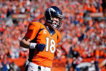 DENVER, CO - JANUARY 19:   Peyton Manning #18 of the Denver Broncos runs off the field against the New England Patriots during the AFC Championship game at Sports Authority Field at Mile High on January 19, 2014 in Denver, Colorado.  (Photo by Kevin C. Co