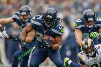 SEATTLE, WA - DECEMBER 29:  Running back Marshawn Lynch #24 of the Seattle Seahawks rushes against the St. Louis Rams at CenturyLink Field on December 29, 2013 in Seattle, Washington.  (Photo by Otto Greule Jr/Getty Images)