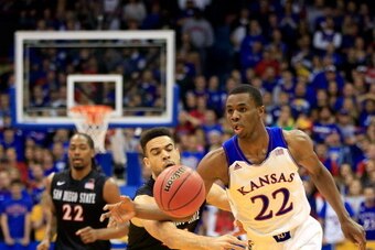 LAWRENCE, KS - JANUARY 05:  JJ O'Brien #20 of the San Diego State Aztecs defends on a fast break by Andrew Wiggins #22 of the Kansas Jayhawks during the game at Allen Fieldhouse on January 5, 2014 in Lawrence, Kansas.  (Photo by Jamie Squire/Getty Images)