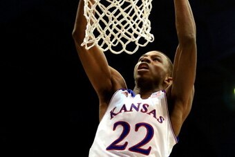 LAWRENCE, KS - NOVEMBER 22:  Andrew Wiggins #22 of the Kansas Jayhawks dunks the ball during the game against the Towson Tigers at Allen Fieldhouse on November 22, 2013 in Lawrence, Kansas.  (Photo by Jamie Squire/Getty Images)