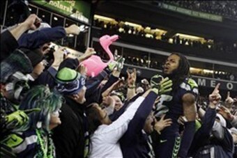 Jan 19, 2014; Seattle, WA, USA; Seattle Seahawks cornerback Richard Sherman (25) celebrates with fans in the stands after the 2013 NFC Championship football game against the San Francisco 49ers at CenturyLink Field. Mandatory Credit: Joe Nicholson-USA TOD