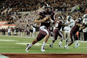 MEMPHIS, TN - DECEMBER 31:  Dak Prescott #15 of the Mississippi State Bulldogs rushes for a touchdown against the Rice Owls during the 55th annual AutoZone Liberty Bowl at Liberty Bowl Memorial Stadium on December 31, 2013 in Memphis, Tennessee.  Mississi