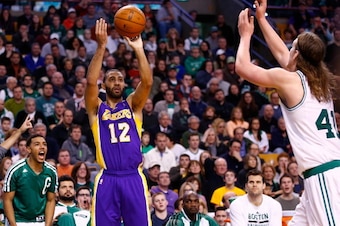 BOSTON, MA - JANUARY 17: Kendall Marshall #12 of the Los Angeles Lakers shoots before scoring a three-point shot in the final minute of the game in front of Kelly Olynyk #41 of the Boston Celtics during the game at TD Garden on January 17, 2014 in Boston,