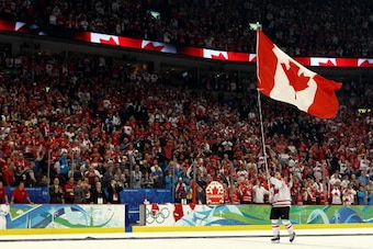 VANCOUVER, BC - FEBRUARY 28:  Sidney Crosby #87 of Canada waves a national flag following his team's 3-2 overtime victory during the ice hockey men's gold medal game between USA and Canada on day 17 of the Vancouver 2010 Winter Olympics at Canada Hockey P