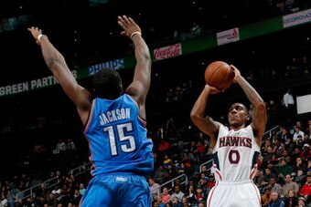 ATLANTA, GA - DECEMBER 10:  Jeff Teague #0 of the Atlanta Hawks shoots against Reggie Jackson #15 of the Oklahoma City Thunder at Philips Arena on December 10, 2013 in Atlanta, Georgia.   NOTE TO USER: User expressly acknowledges and agrees that, by downl