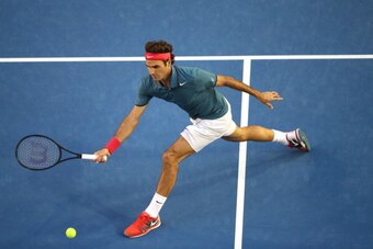 MELBOURNE, AUSTRALIA - JANUARY 22:  Roger Federer of Switzerland plays a forehand in his quarterfinal match against Andy Murray of Great Britain during day 10 of the 2014 Australian Open at Melbourne Park on January 22, 2014 in Melbourne, Australia.  (Pho